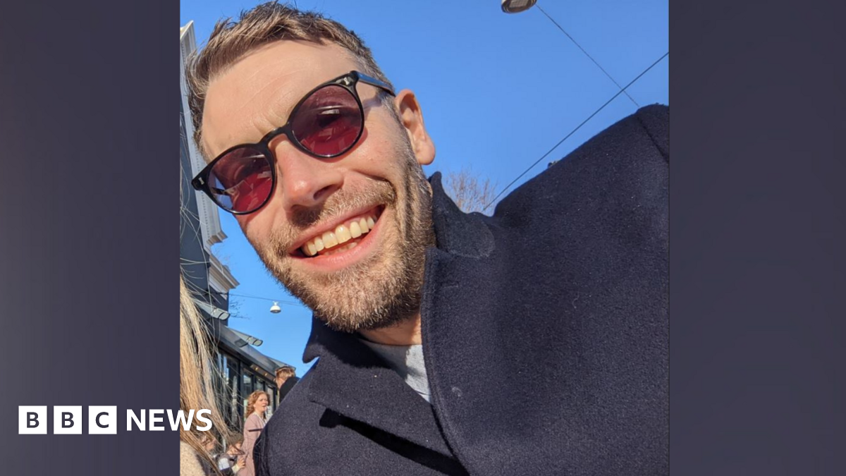 Aran Potkin from Farnham. Aran is wearing sunglasses and has fair hair and a short beard. He is wearing a navy coat.