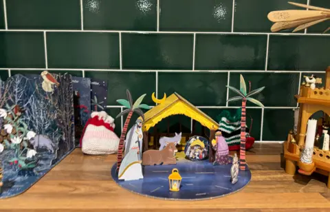 The nativity scene shows a shepherds, wise men and animals in a barn