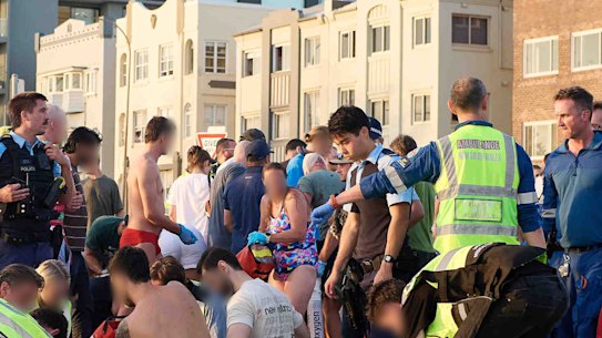 Members of the public help emergency services following the mass shooting at Bondi Beach.