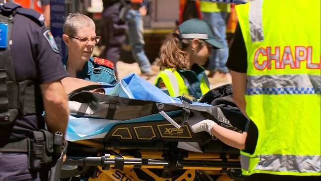 Paramedics secure the injured man on a stretcher at the West End site.