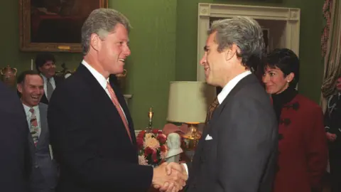Clinton Presidential Library Former US President Bill Clinton is photographed shaking hands with Jeffrey Epstein as Ghislaine Maxwell watches from behind in September 1993 at the White House.