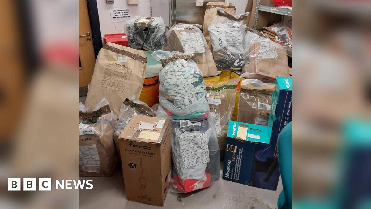 A pile of parcels on the floor in a evidence store room