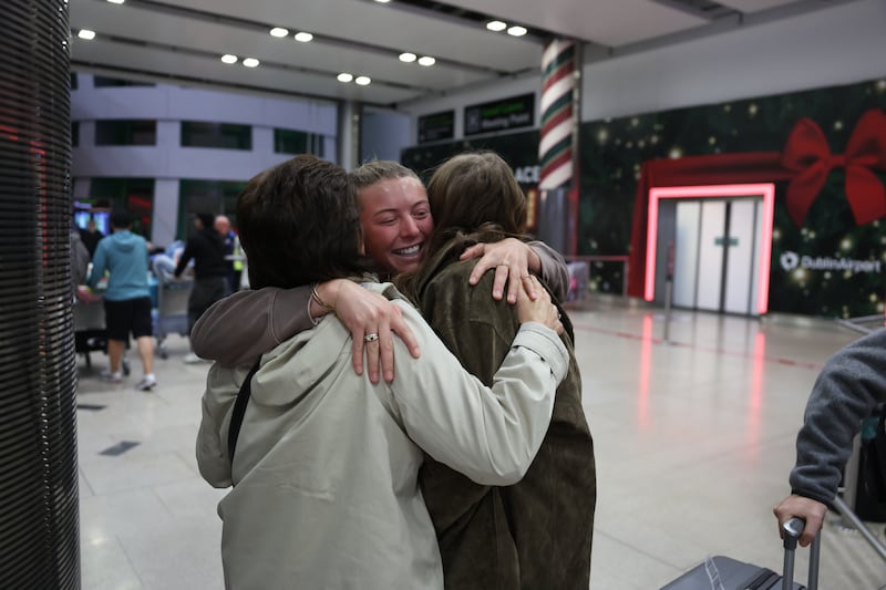 Sophie Buller embraces her mother Vina and sister Alex at Dublin Airport after arriving from Sydney. Picture: Enda O'Dowd