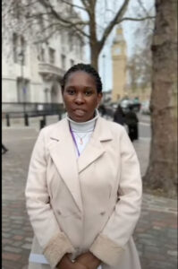 Photo of a UNISON member, Audrey, standing for the camera on the street