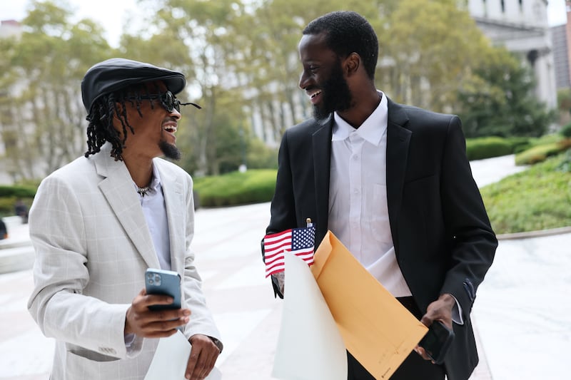 NEW YORK, NEW YORK - OCTOBER 15: People celebrate outside of Jacob K. Javitz Federal Building after attending their Naturalization ceremony on October 15, 2025 in New York City. Immigration and Customs Enforcement (ICE) agents and other federal agencies continue to make detainments in immigration courts as people attend their court hearings despite a government shutdown thats going on it's fourtheenth day. (Photo by Michael M. Santiago/Getty Images)