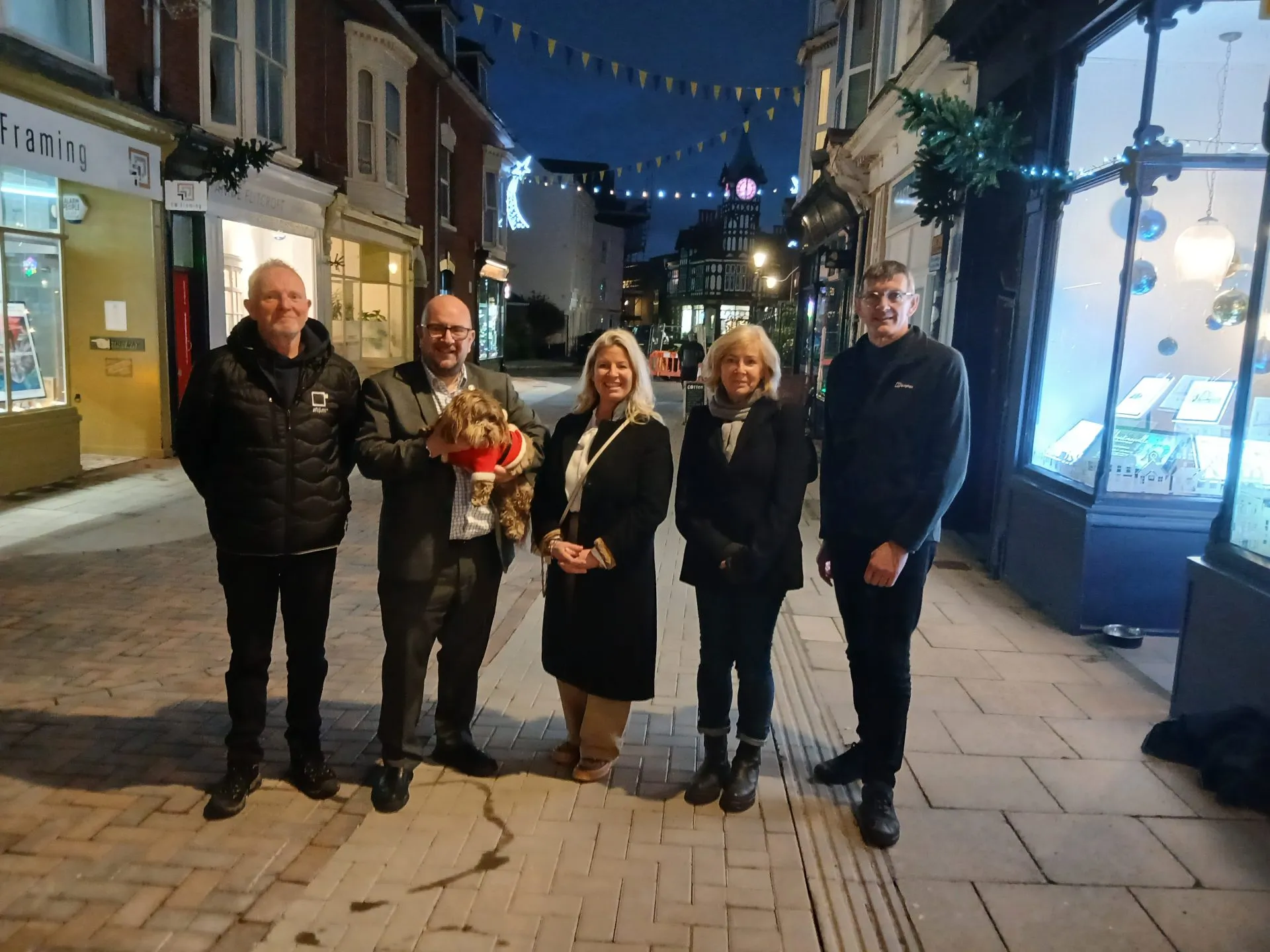 A group of people stand on Castle Road 