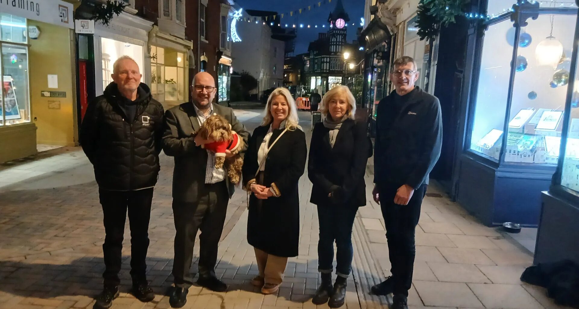 A group of people stand on Castle Road
