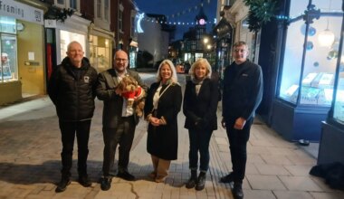 A group of people stand on Castle Road
