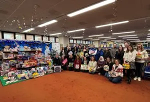 The companies who donated the gifts alongside the community groups who will distribute them to families.