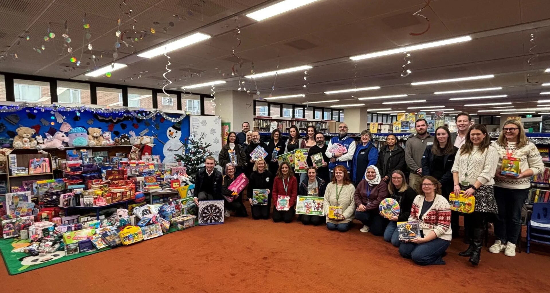 The companies who donated the gifts alongside the community groups who will distribute them to families.