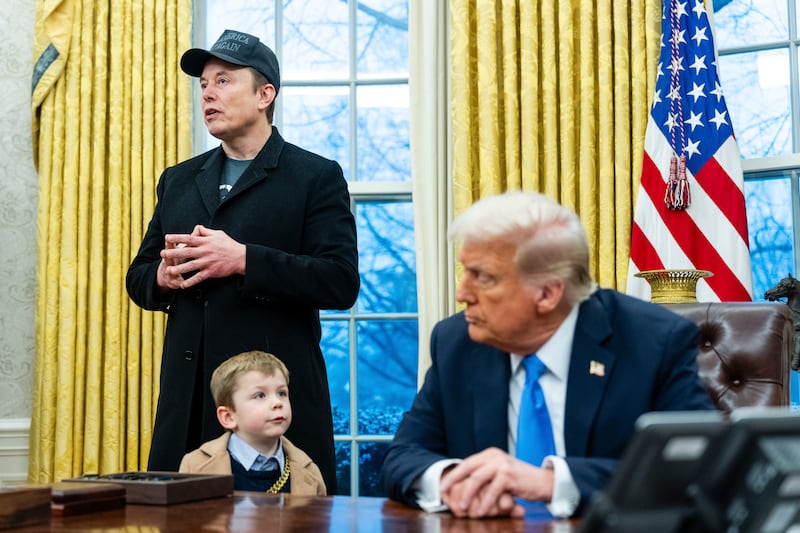 Elon Musk, with son X, speaks to reporters alongside Donald Trump at the Oval Office in February. Photograph: Eric Lee/The New York Times