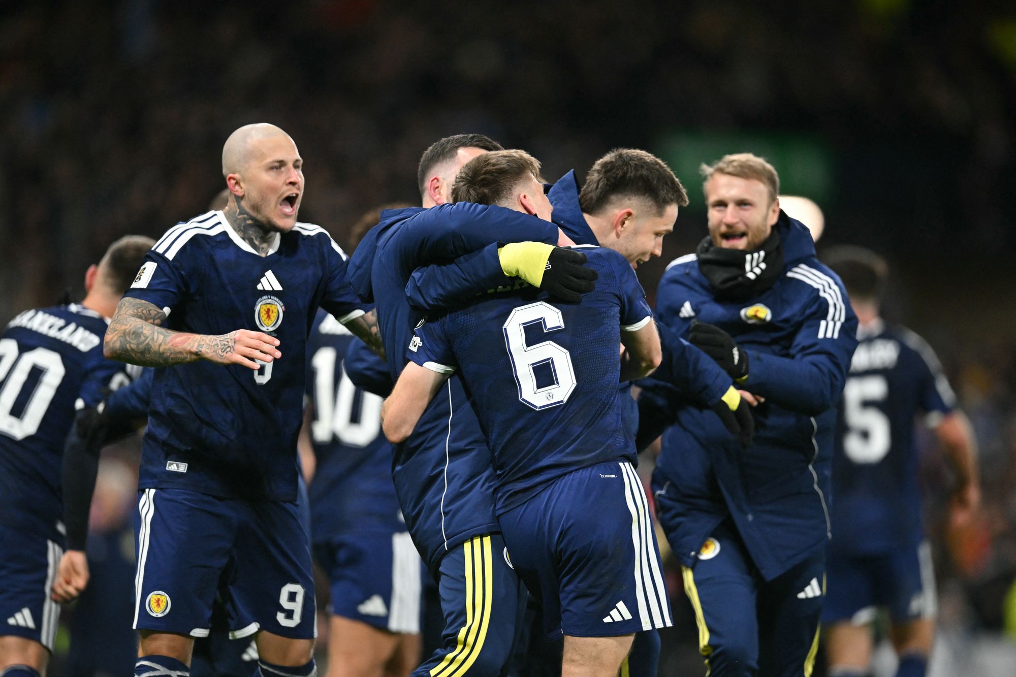 Scotland players celebrate on the pitch after the World Cup 2026 qualification match against Denmark on 18 November