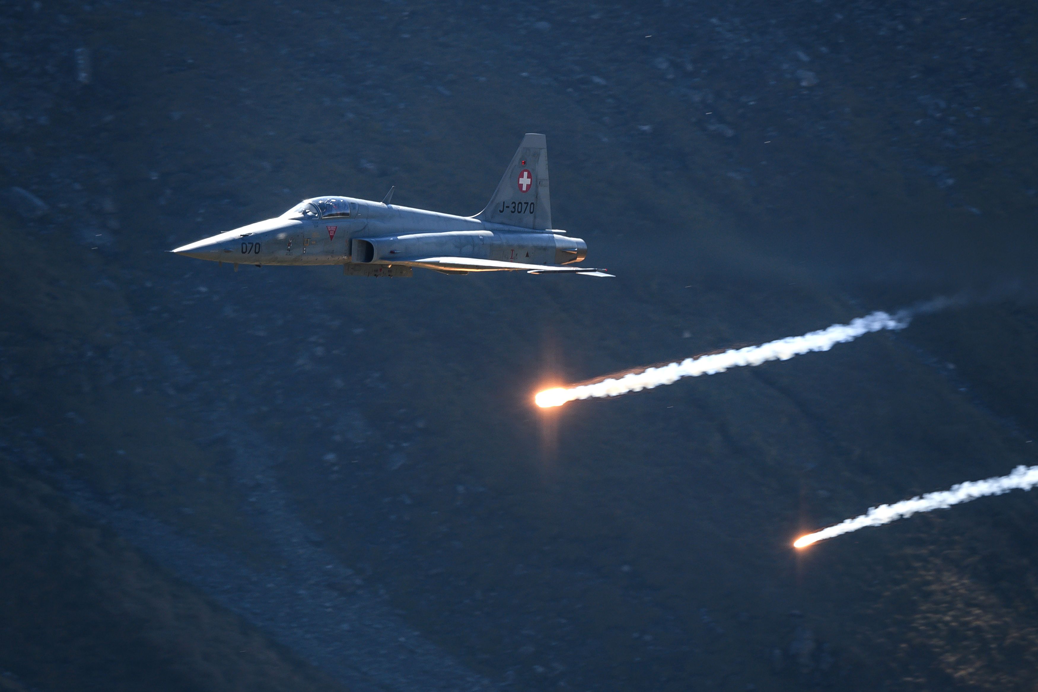 A Swiss Air Force F-5 Tiger fighter jet releases flares over Brienz in the Bernese Alps on October 10, 2018, during the annual live fire event of the Swiss Air Force at the Axalp. - At an altitude of 2,200 meters above sea level, spectators attended a unique aviation display performed at the highest air force firing range in Europe. (Photo by Fabrice COFFRINI / AFP) (Photo by FABRICE COFFRINI/AFP via Getty Images)