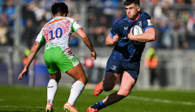 Leinster's Dan Sheehan runs with the ball as Harlequins' Marcus Smith prepares to challenge during the 2025 European Rugby Champions Cup round-of-16 match.