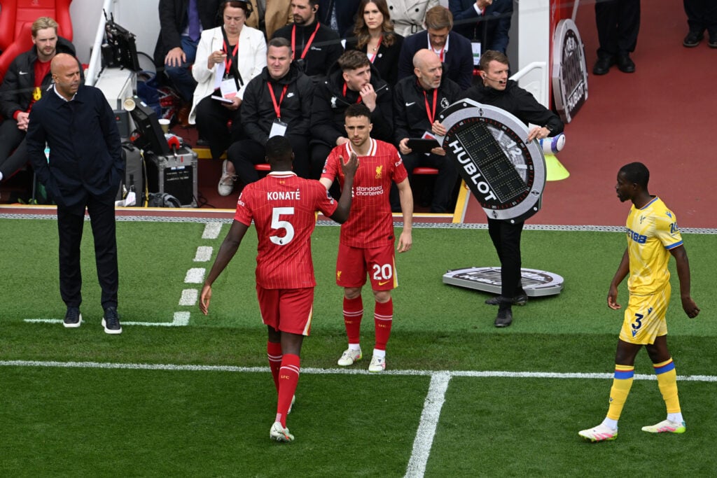 Ibrahima Konate shakes hands with Diogo Jota after being substituted during Liverpool's Premier League match against Crystal Palace at Anfield.