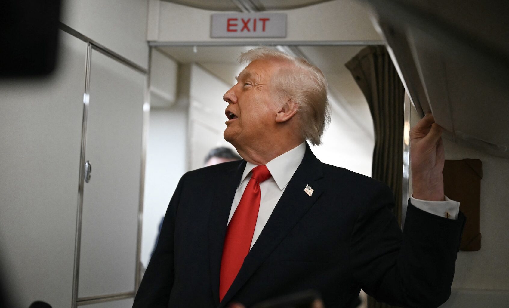US President Donald Trump speaks to the media aboard Air Force One on December 9, 2025, en route to deliver remarks in Pennsylvania. ((Photo by Andrew Caballero-Reynolds/Getty Images)
