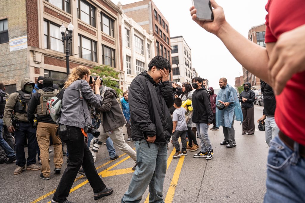 Federal agents force people back as they detain several people at the Intensive Supervision Appearance Program office, 2245 S. Michigan Ave., in South Loop on June 4, 2025.