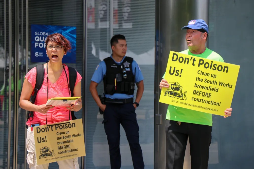 impassioned environmental group pickets outside of Chicago Quantum event with a police officer standing guard.