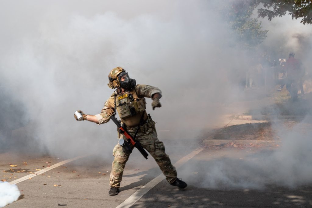 Agents deploy smoke bombs at 105th and Avenue N on Chicago's East Side during a tense standoff with residents.
