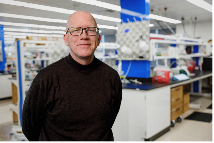 Stephen Betz in his lab posing for a photo.
