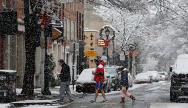 Pedestrians walk across Third Street in Old City as snow fell on Dec. 14.