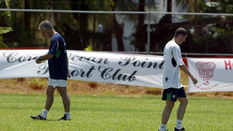 Mick McCarthy and Roy Keane pass each other during training in Saipan on May 21st, 2002. Photograph: Andrew Paton/Inpho