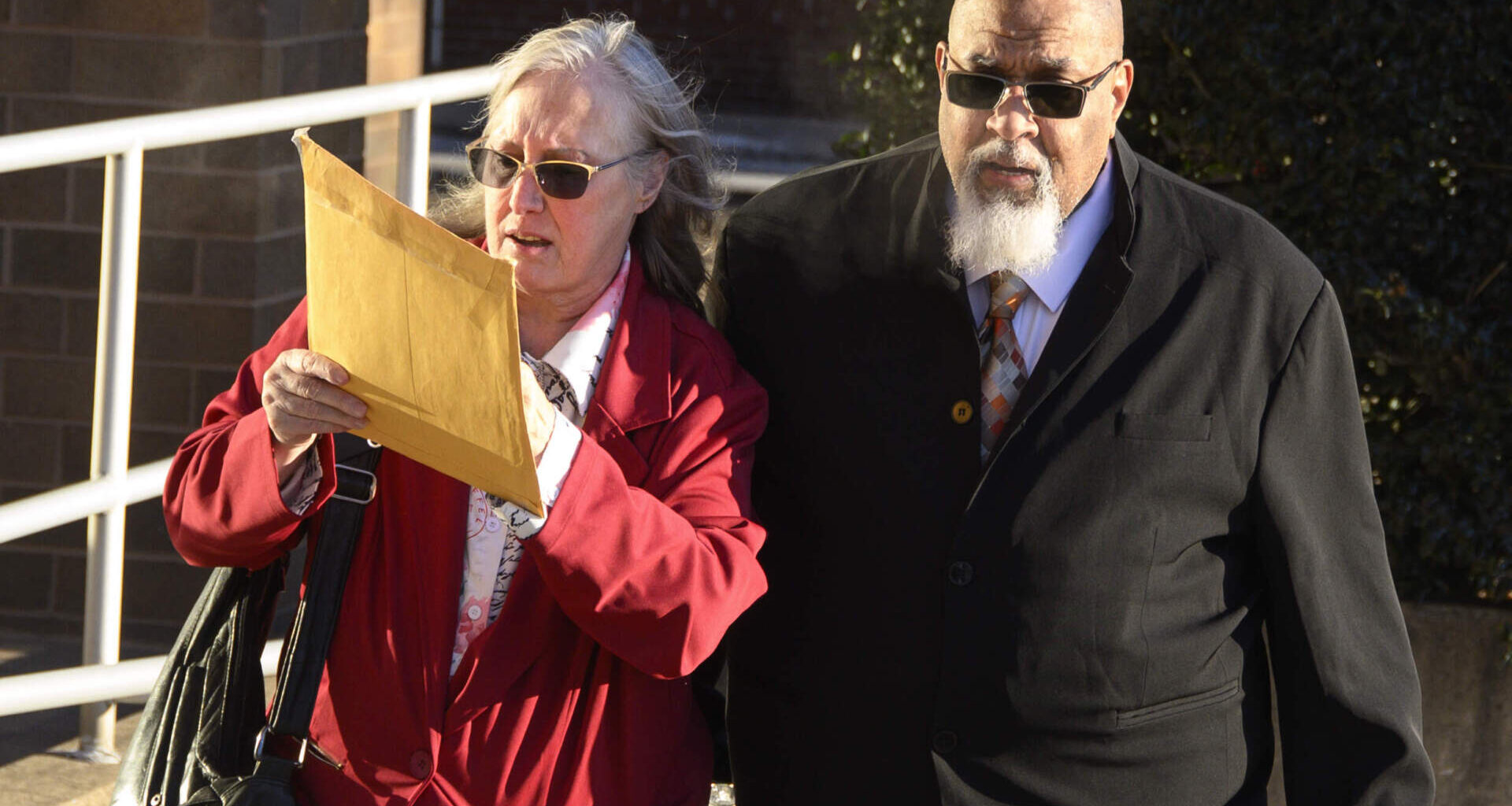 Cedric Lodge, former morgue manager at Harvard Medical School, and his wife, Denise, enter the Herman T. Schneebeli Federal Building and Courthouse for a sentencing hearing in Williamsport, Pennsylvania on Tuesday, Dec. 16. (Ralph Wilson for WBUR)