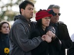 From left, Kelland Harrison, his mother Paula Tin Nyo and her husband David Williams watch as Tyber Harrison's grave is exhumed on Tuesday, Dec. 30, 2025 at Skyline Memorial Gardens in Portland, Ore.