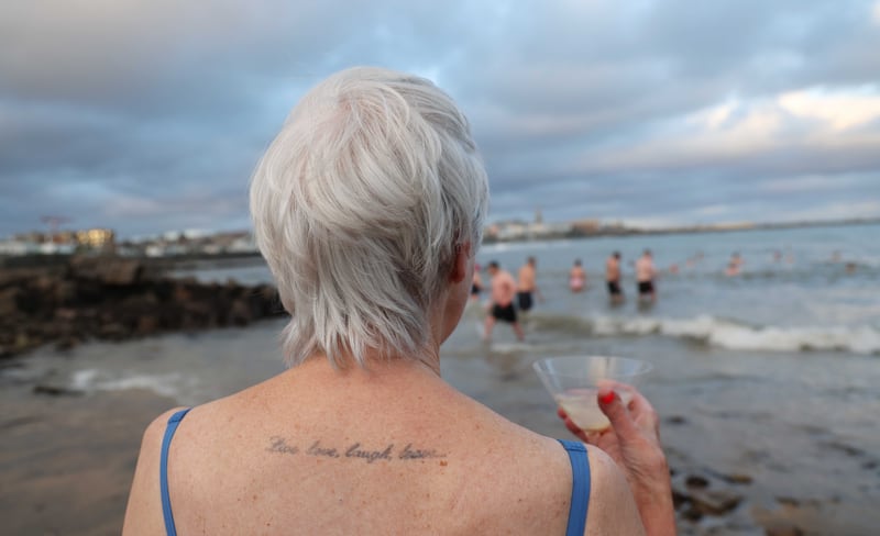  Elizabeth Fuller (81) from Sandyford enjoys  a martini after a Christmas Day Swim  with her daughter Jessica at Sandycove in South Co. Dublin. Photo: Bryan O’Brien / The Irish Times 
