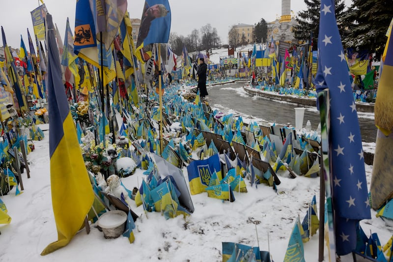 A priest stands before the Memorial for the Fallen Ukrainian and Foreign Fighters on the Independence Square in Kyiv on December 26th. Photograph: AFP via Getty Images