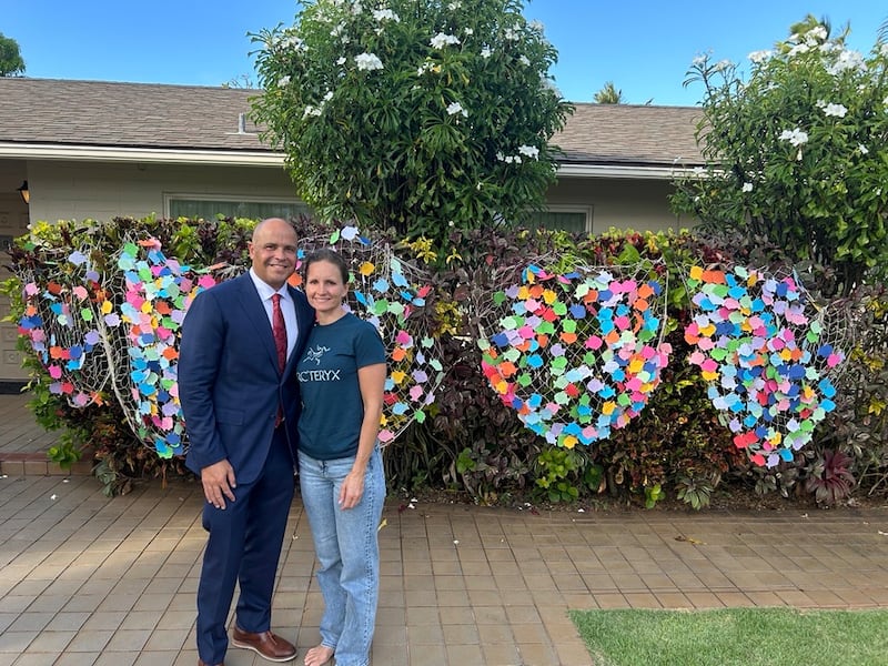 BYU–Hawaii President John S.K. Kauwe III and his wife, Sister Monica Kauwe, stand in front of nets full of paper fish containing well wishes from BYU–Hawaii students. President Kauwe is undergoing chemotherapy to treat cancer.
