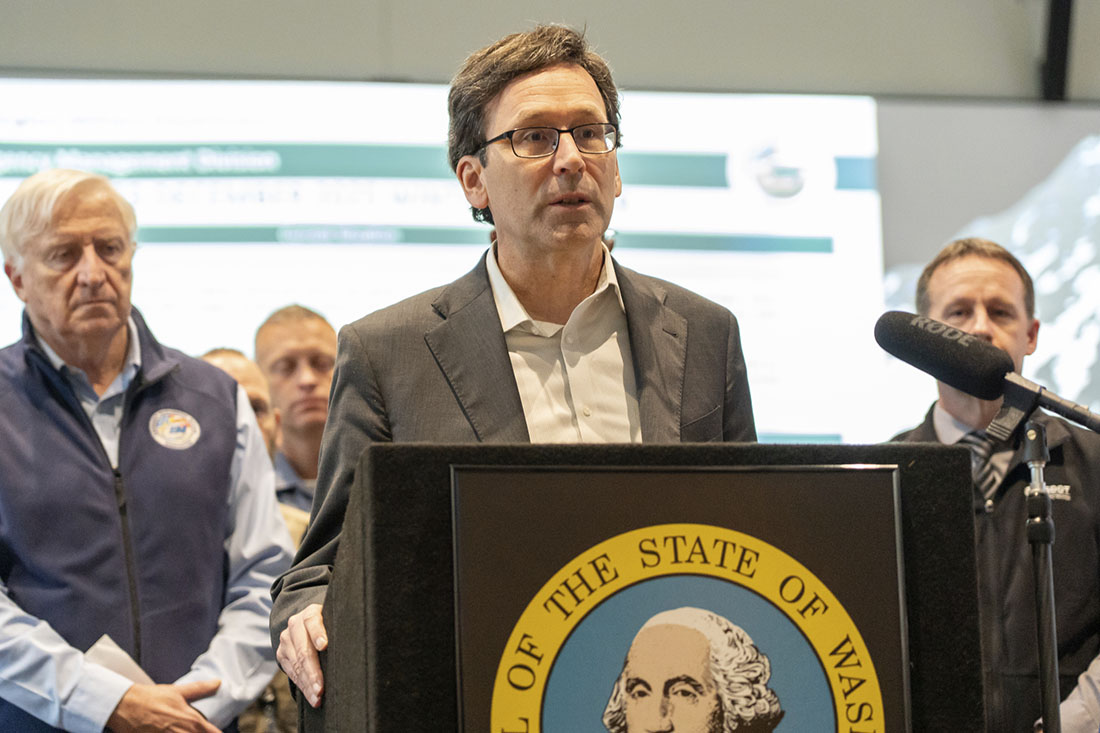 Governor Bob Ferguson speaks at a podium at the State Emergency Operations Center.