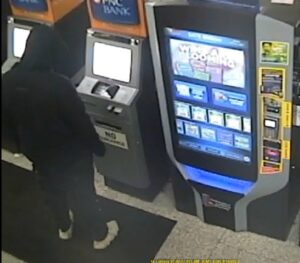 Surveillance video of a man at an ATM in a convenience store