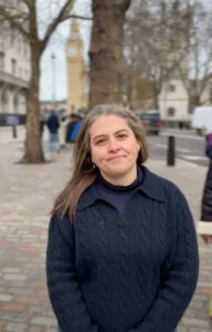 Photo of a UNISON member, Suzanna, standing for the camera on the street