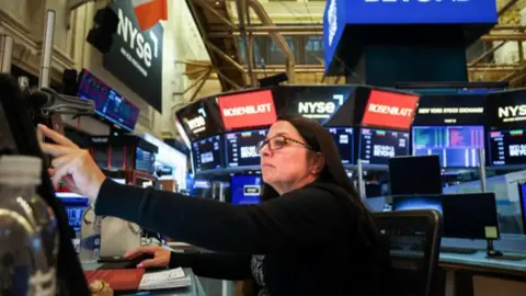 Michael Nagle/Bloomberg via Getty Images A trader works on the floor at the New York Stock Exchange.