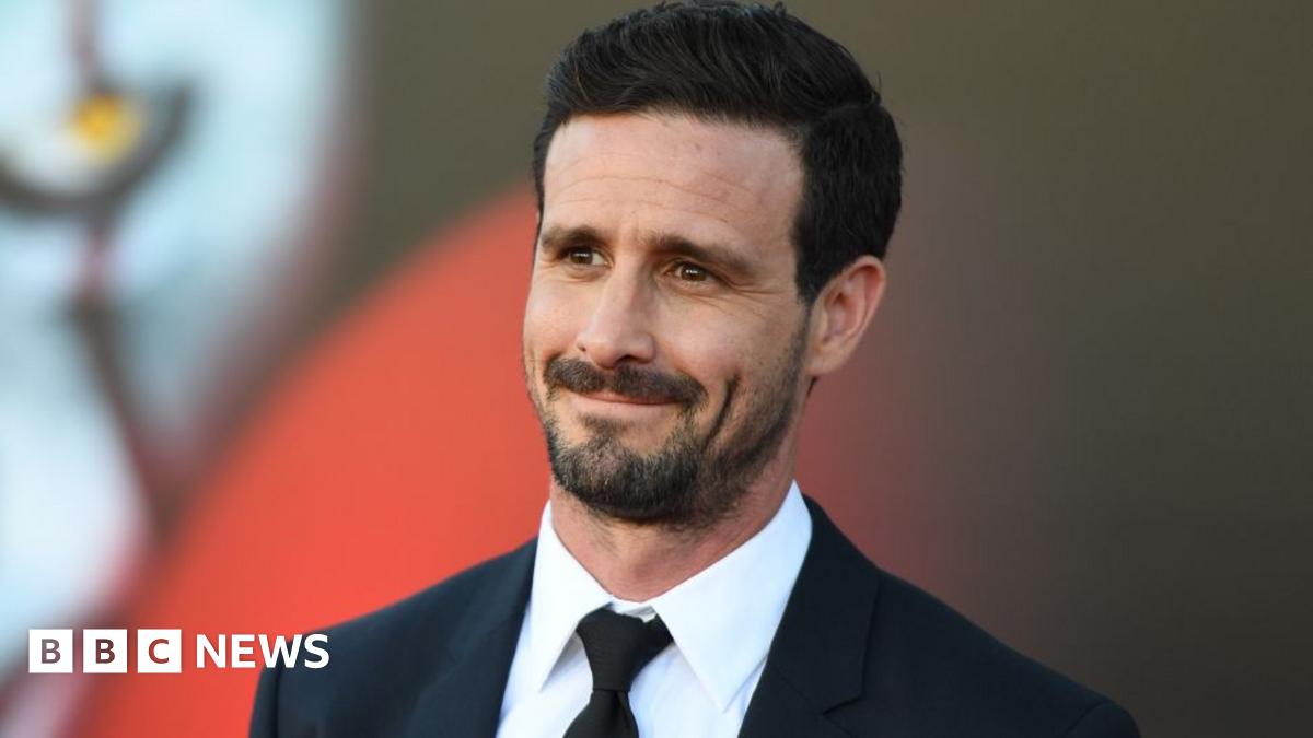 US actor James Ransone arrives for the World premiere of It Chapter Two at the Regency Village theatre in Westwood, California on 26 August, 2019. He has black hair and beard and is wearing a white shirt, black suit and black tie.