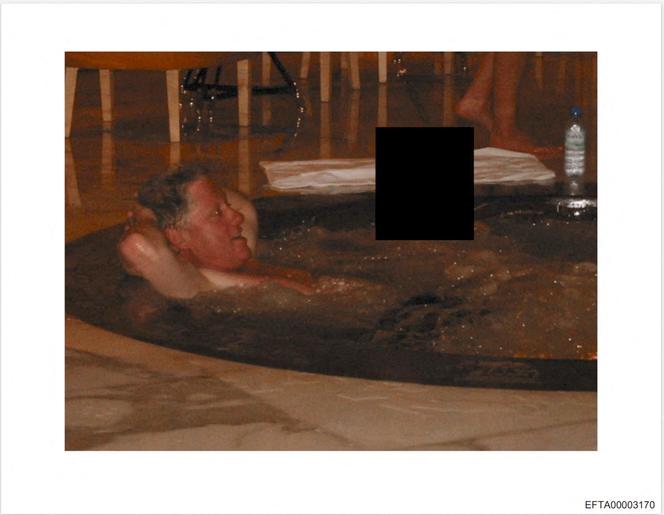 This photo provided by the US Justice Department on December 19, 2025 shows an undated picture of former US president Bill Clinton in a jacuzzi at an undisclosed location as the Justice Department began releasing the long-awaited records from the investigation into the politically explosive case of convicted sex offender Jeffrey Epstein. 