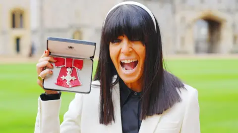 PA Wire/PA Images Claudia Winkleman after being made a Member of the Order of the British Empire by King Charles III during an Investiture ceremony at Windsor Castle, Berkshire. Picture date: Tuesday December 9, 2025.