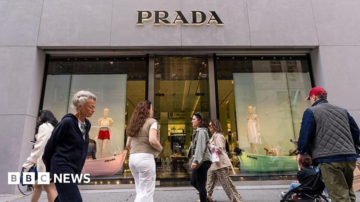 People walk by the Prada store on Madison Avenue in New York City