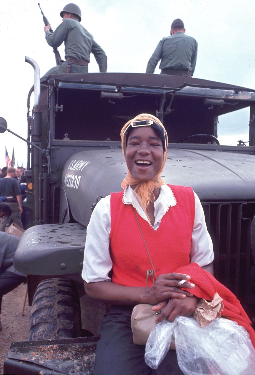 This photo from the Matt Herron photography archive shows Doris Wilson, 20, a resident of Marion, Alabama, smoking a cigarette on the front of a military vehicle along the route of the Selma to Montgomery march in March 1965.