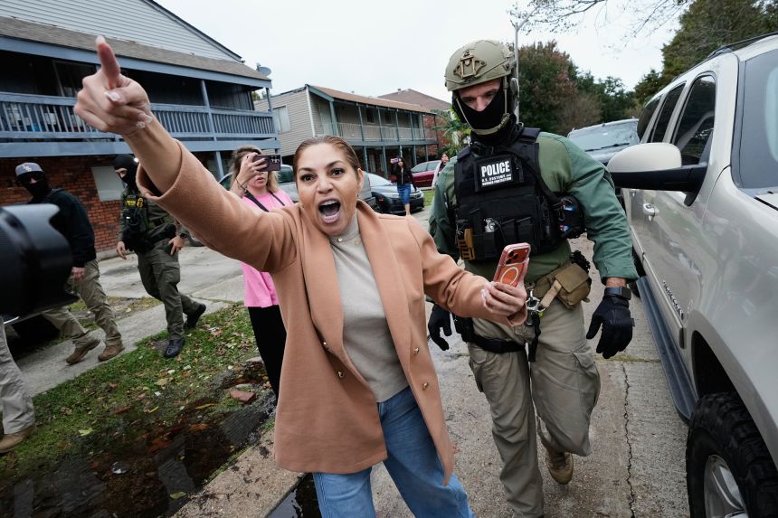 Wilma Fuentes yells at Customs and Border Patrol commander Gregory Bovino and some of his agents as they walk through a neighborhood during an immigration crackdown in Kenner, Louisiana, on Friday.