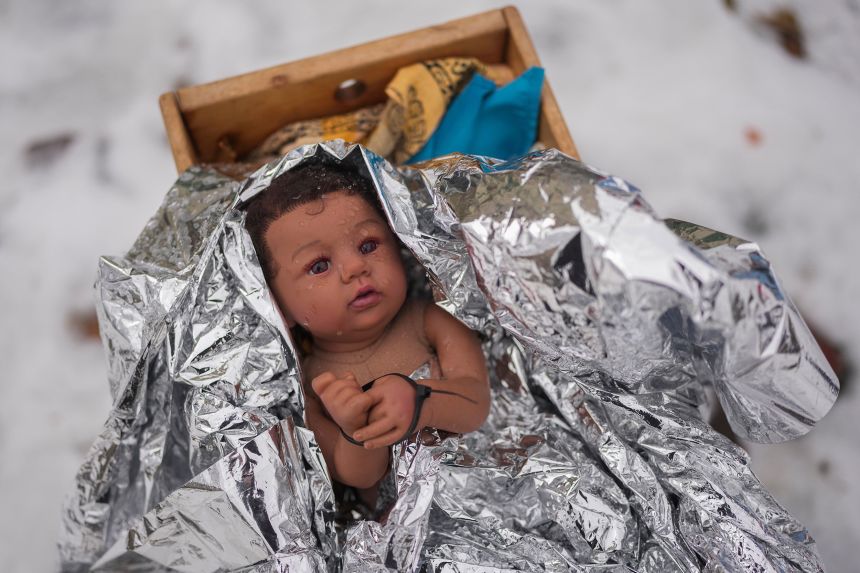 A doll representing the baby Jesus is zip-tied in the Nativity scene outside of Lake Street Church of Evanston.