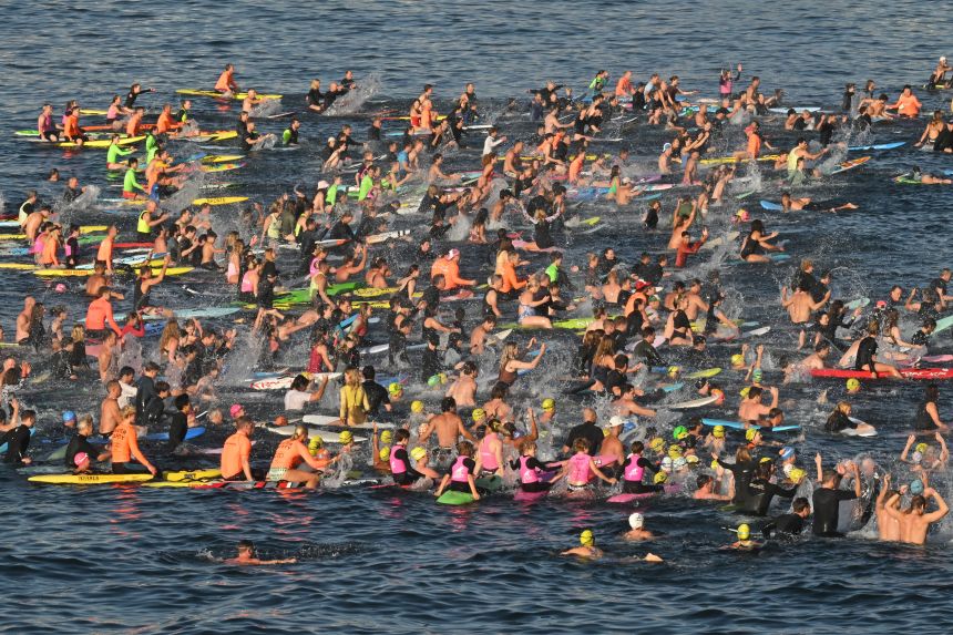 Surfers and swimmers hold a tribute in the sea at Bondi Beach, in Sydney, on December 19, 2025, following last Sunday's shooting.