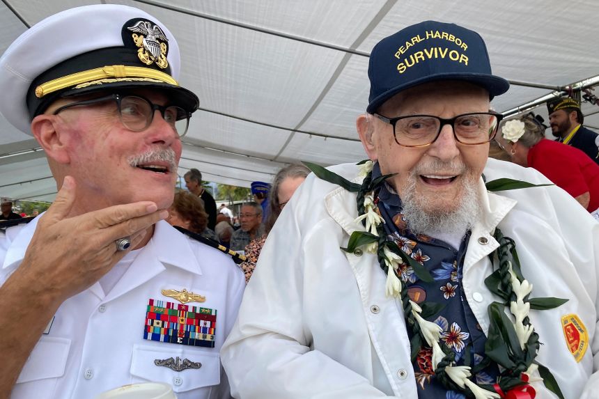 Ira Schab, right, talks with reporters while sitting next to his son, retired Navy Commander Karl Schab, on December 7, 2022, in Hawaii.
