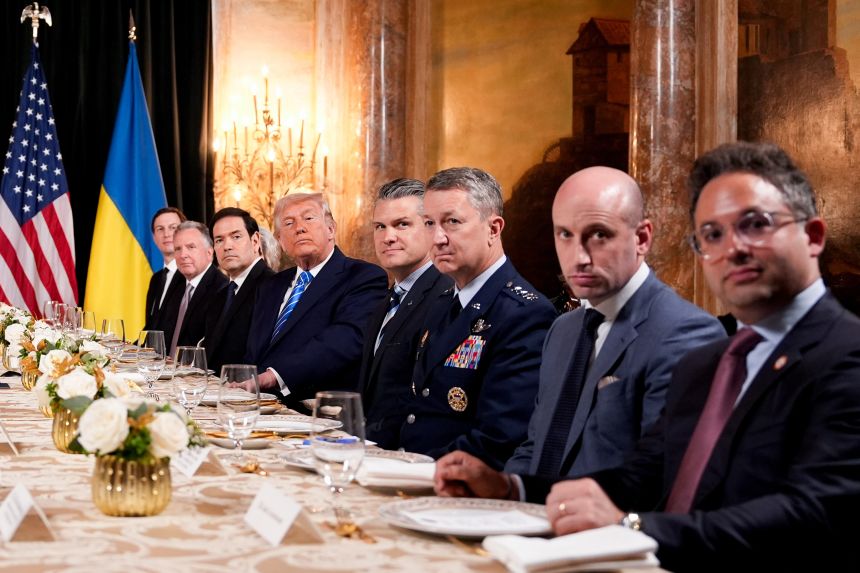 President Donald Trump, accompanied by officials and allies, meets with Ukrainian President Volodymyr Zelensky at his Mar-a-Lago club in Palm Beach, Florida, on December 28, 2025.