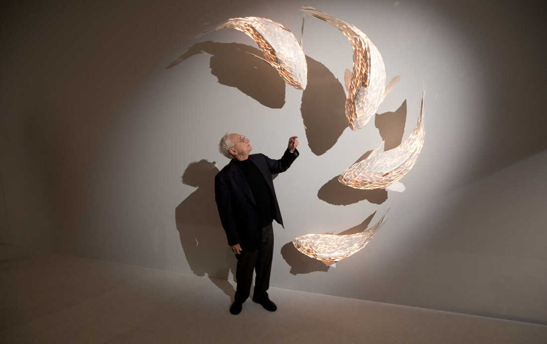Gehry stands next his fish lamps at his exhibition at the Gagosian Mayfair gallery, in central London, in November 2013. As a child, Gehry remembers watching carp — destined to be dinner — swimming in his grandmother's bathtub.