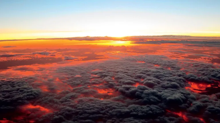Capturing a glowing sunset from high above the clouds