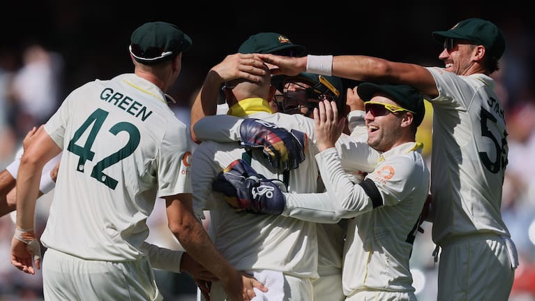 Australia's Nathan Lyon, second left, is congratulated by teammates after dismissing England's Ben Stokes during play on day four of the third Ashes cricket test between England and Australia in Adelaide, Australia.