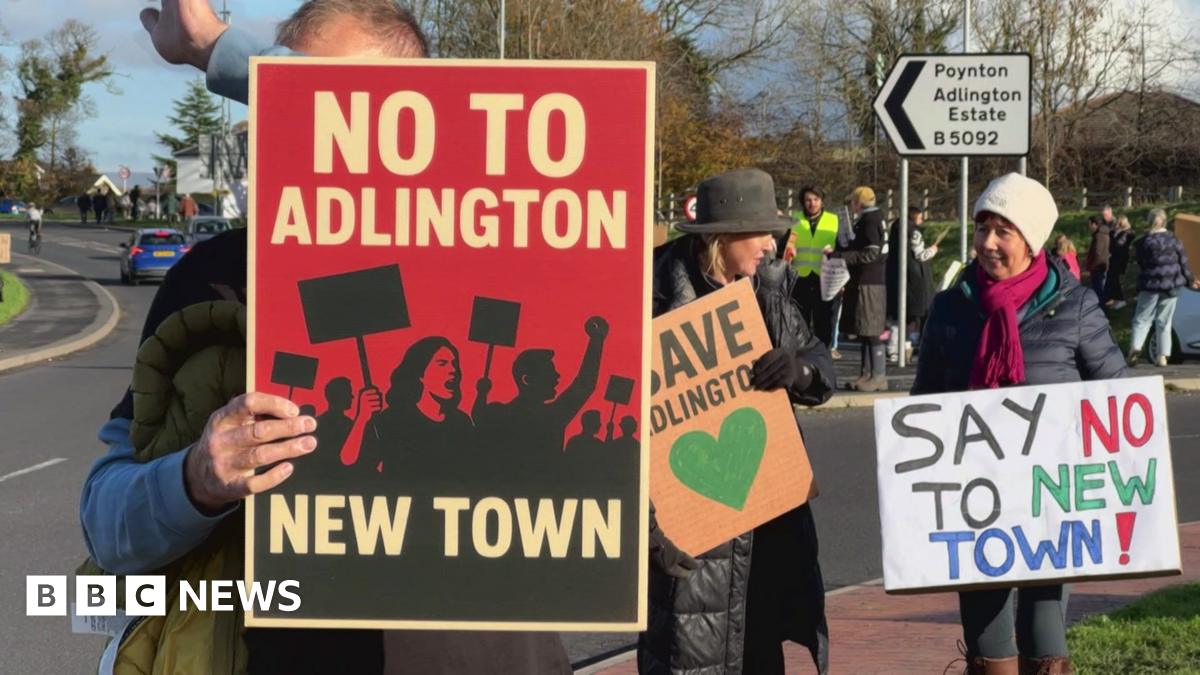 Protesters holding signs saying no to the Adlington new town