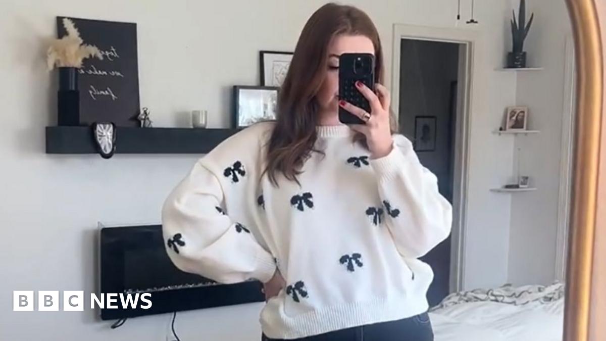 A woman looks in the mirror holding her phone, with text saying 'I wish I knew sooner that I could lose post-baby weight with a medicated weight loss treatment from MedExpress'